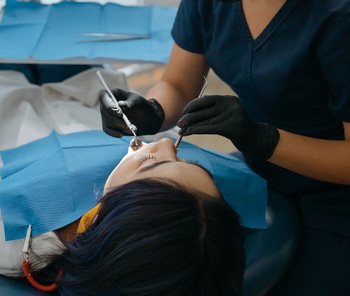 The Art of Drawing Readers In: Your attractive post title goes here Dentist performing dental care procedure on patient in clinic setting.