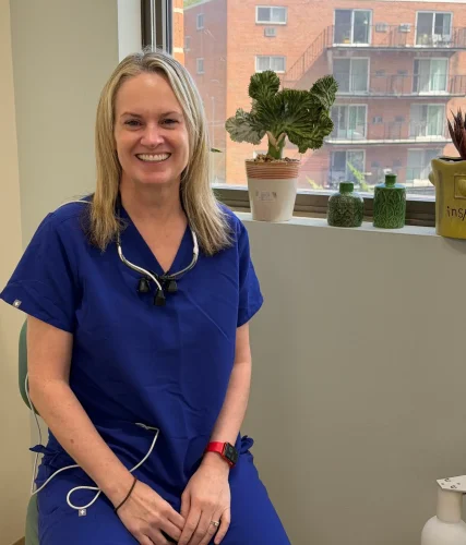 Kim the registered dental hygienist sitting by the window