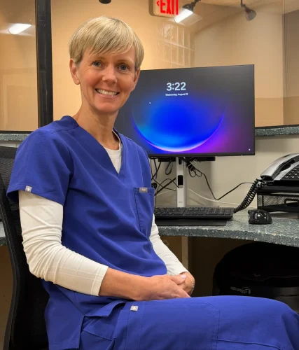 Nicola, the Patient Coordinator, smiling at her desk.
